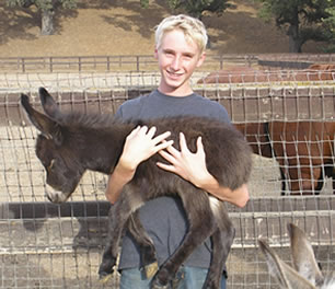 Chad holding a Miniature Donkey Foal